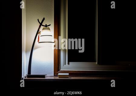 Warm and vintage Interior light near the dark window Stock Photo