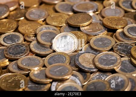 Full frame background of 1 euro coin placed on pile of shiny coins Stock Photo