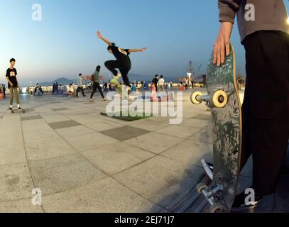 Skateboarders on the new Western district harbourfront promenade, which used to be the Western Wholesale Food Market, Hong Kong, China. Stock Photo