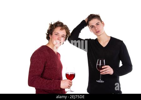 Holidays and weekends. Young attractive couple drinking red wine. White background. Stock Photo