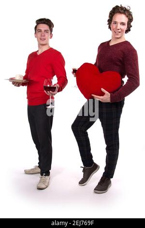 Holidays and weekends. Young attractive couple drinking red wine. White background. Stock Photo