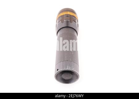 black metal flashlight on a white background Stock Photo