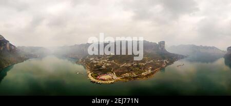 (210222) -- QIANXI, Feb. 22, 2021 (Xinhua) -- Aerial panoramic view of Huawu Village is seen in Qianxi County of Bijie City, southwest China's Guizhou Province, Feb. 21, 2021. Located in the deep mountainous area of Xinren Miao Township of Guizhou, Huawu Village is famous for its amazing landscapes. In recent years, with the efforts of local government, the village develops planting, cultivation, and tourism while relocating poverty-stricken people. Nowadays Huawu has taken on a new look in the new year, with various industries greeting booming development. (Xinhua/Yang Wenbin) Stock Photo
