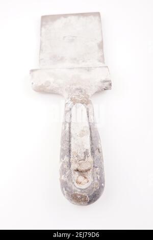 dirty spatula for putty on a white background Stock Photo
