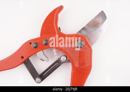 red knife for plastic pipes on a white background Stock Photo