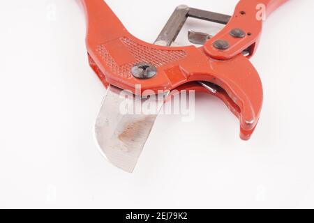 red knife for plastic pipes on a white background Stock Photo