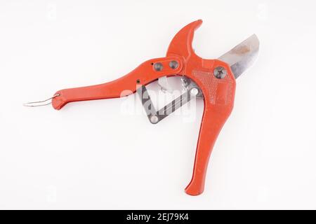 red knife for plastic pipes on a white background Stock Photo