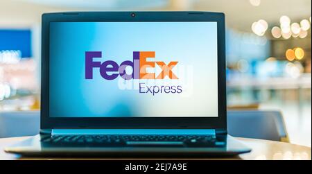 POZNAN, POL - AUG 8, 2020: Laptop computer displaying logo of FedEx Corporation, an American multinational delivery services company headquartered in Stock Photo