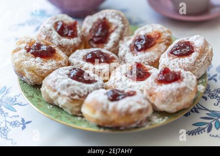 A plate of donuts filled with jam and coated in sugar. Stock Photo