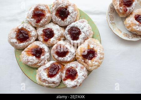 Top view on a plate of donuts filled with jam and coated in sugar. Stock Photo