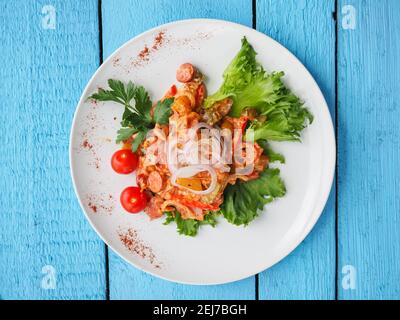 Chicken salad on blue wooden background Stock Photo