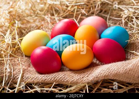 Colorful Easter eggs in a heap of hay Stock Photo