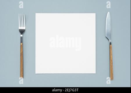 Flat lay overhead view blank recipe paper page with mockup text space, invitation card and cutlery on neutral background Menu recipe book food blog de Stock Photo