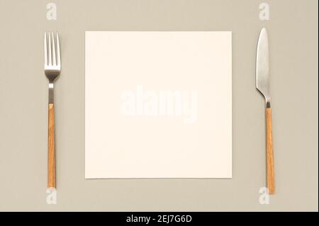 Flat lay overhead view blank recipe paper page with mockup text space, invitation card and cutlery on neutral background Menu recipe book food blog de Stock Photo