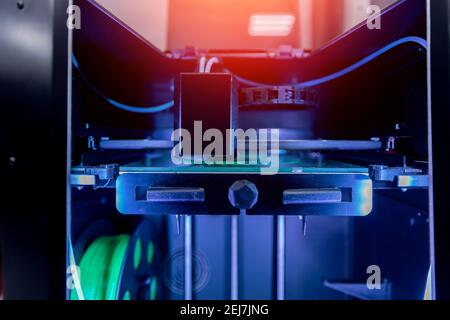 Modern 3D printer printing figure home close-up macro in innovation laboratory, black color. Stock Photo