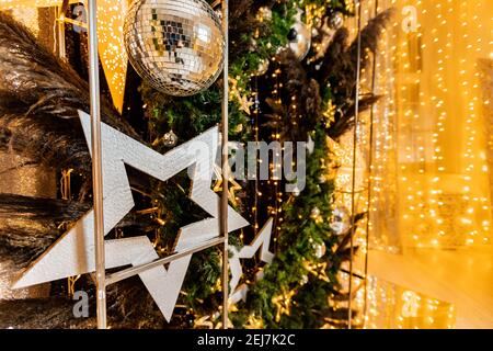 Garland in shape of Led Christmas star in decor, blurred bokeh background. Stock Photo