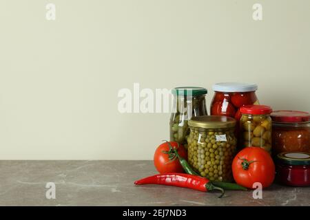 Jars with different pickled food on gray table Stock Photo