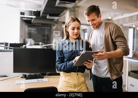 Programmers cooperating at IT company developing apps Stock Photo