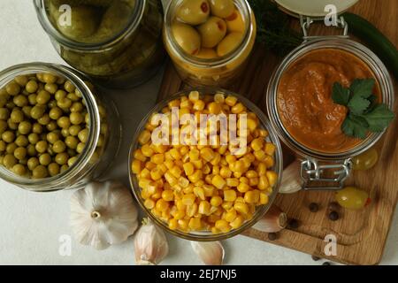 Different pickled food and ingredients on white textured background Stock Photo