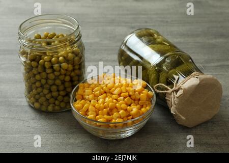 Pickled cucumbers, corn and peas on gray background Stock Photo