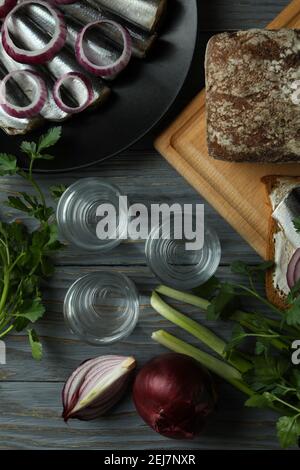 Shots of vodka and tasty snacks on wooden table, top view Stock Photo