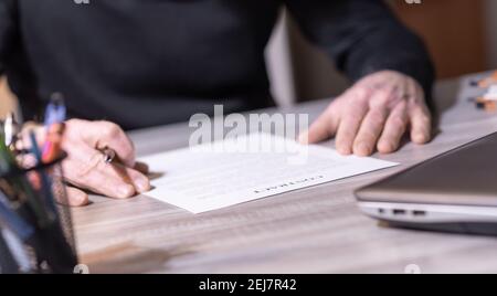 Senior businessman reviewing terms of contract at office Stock Photo