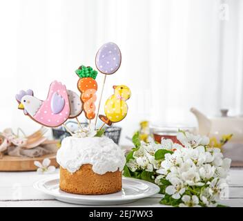 Easter composition with beautifully decorated Easter cake and spring flowers. The concept of preparing for the Easter holiday. Stock Photo