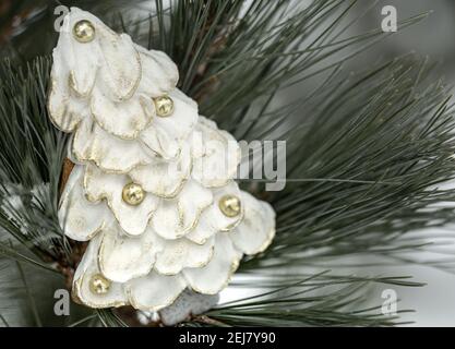 Festive gingerbread in the shape of a Christmas tree on a blurred background. Christmas holiday concept. Stock Photo