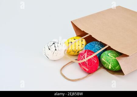 Five decorated chicken eggs are in a supermarket paper bag. Stock Photo