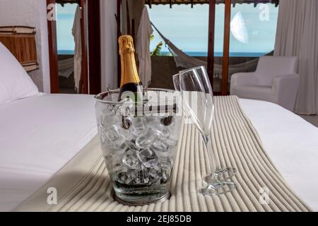 Hotel bed with champagne on the beach Stock Photo
