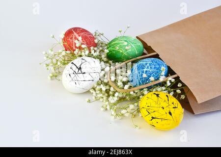 Colored eggs in a paper bag. Delivery on Easter. Stock Photo