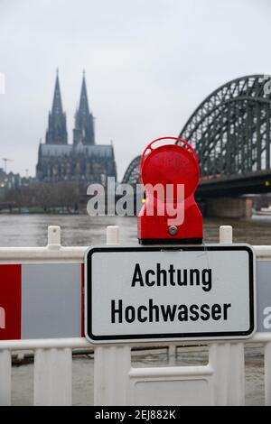 'Achtung Hochwasser - attention high tidewater' sign on the river Rhine in Cologne Stock Photo