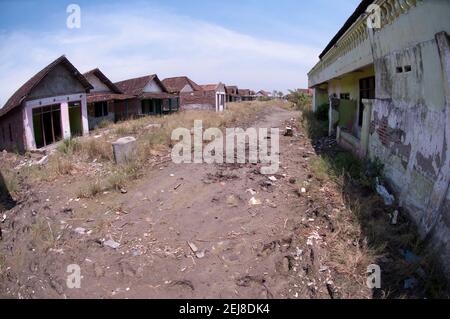 Abandoned village in dried mud following flooding by mud lake environmental disaster which developed after drilling incident, Porong Sidoarjo, near Su Stock Photo