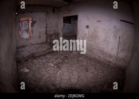 Abandoned house with dried mud on floor following flooding by mud lake environmental disaster which developed after drilling incident, Porong Sidoarjo Stock Photo