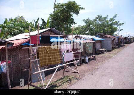 Refugee camp next to abandoned village following flooding by mud lake environmental disaster which developed after drilling incident, Porong Sidoarjo, Stock Photo