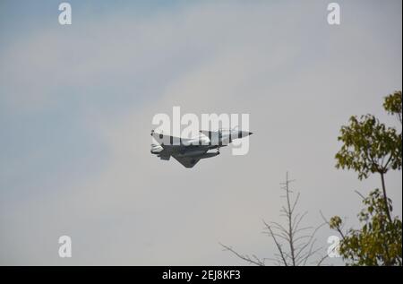 Chinese military aircraft coming in to land at Jiaxing air base. They fly low over a local public park. This is a single engine Chengdu J10. feb 2020 Stock Photo