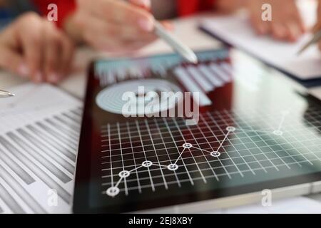 Business woman pointing with stylus on information in digital tablet closeup Stock Photo