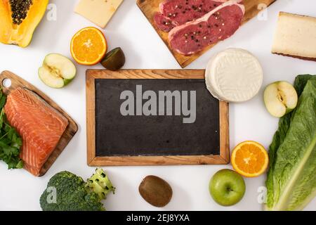 Vitamin A in food and blackboard mockup isolated on white background Stock Photo