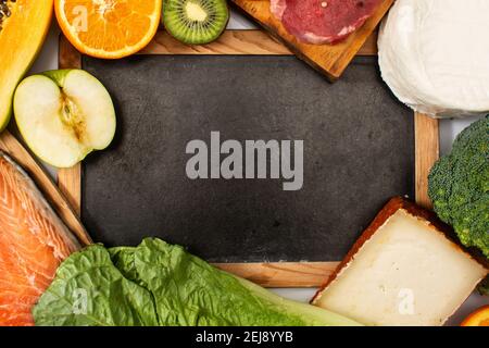Vitamin A in food and blackboard mockup background Stock Photo