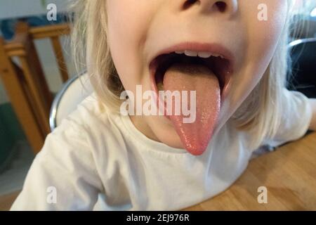 Little girl sticking out her tongue Stock Photo