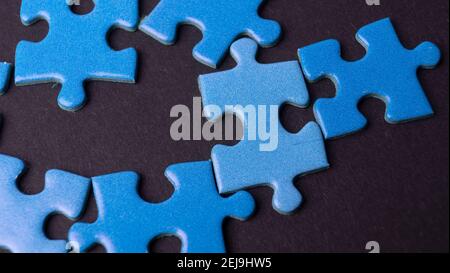 scattered puzzle pieces on colored background Stock Photo
