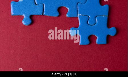 scattered puzzle pieces on colored background Stock Photo