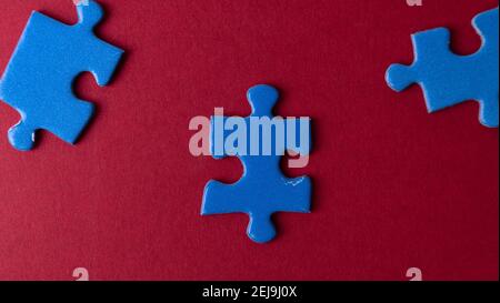 scattered puzzle pieces on colored background Stock Photo