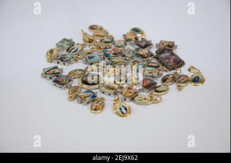 Medal, Religious Catholic medals of virgins in selective focus on white background Stock Photo