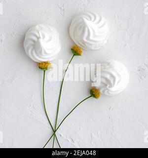 White meringue flowers bouquet on a white backdrop. Top view. Stock Photo
