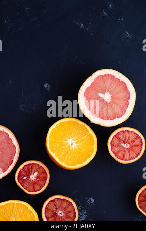 Halves of citrus on a blue backdrop. Top view. Stock Photo