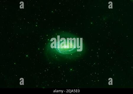 Green spiral galaxy on a dark background. Elements of this image were furnished by NASA. High quality photo Stock Photo