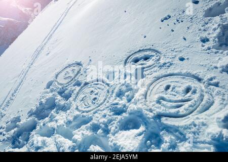 Happy smile faces in the snow on the mountain with sun flare Stock Photo