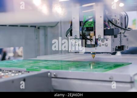 SMD pick and place machine assembling computer circuit board - front view Stock Photo