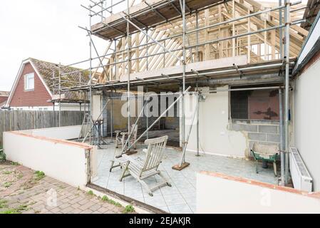 A residential house gets the roof converted to double the size of the house giving the owners more space. Stock Photo